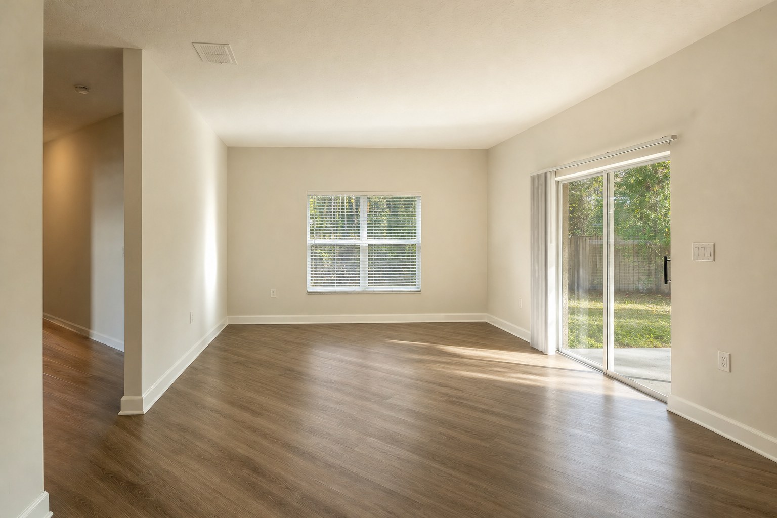 Empty living room with clean hard flooring ready for a final inspection